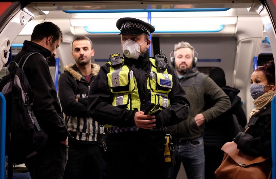  A police office taking the right precautions on a busy Tube today