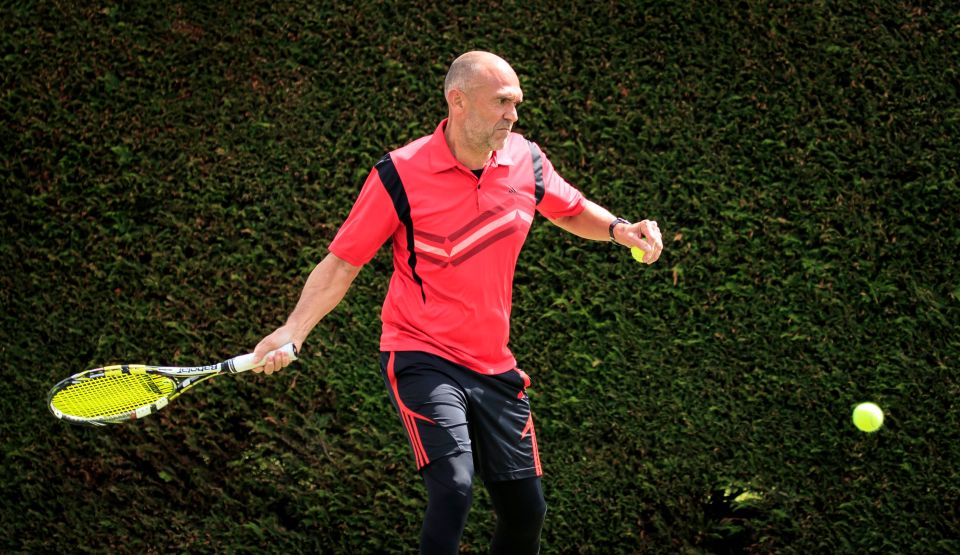  A tennis fan practises his swing on a court in York today