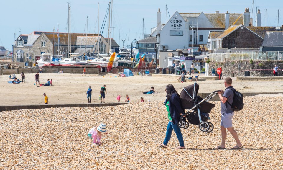  People start to return to the beach at Lyme Regis on the first sunny Saturday since the Government coronavirus restrictions were eased