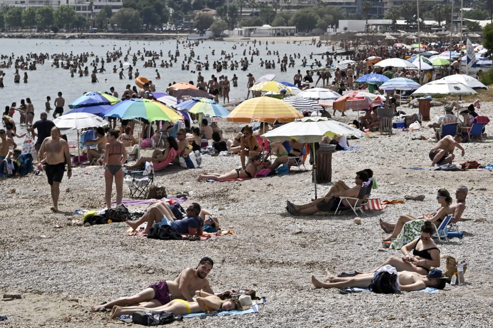  Beachgoers soaked up the sun and sea during the official reopening of Greek beaches to the public on May 16 in Varkiza, Greece