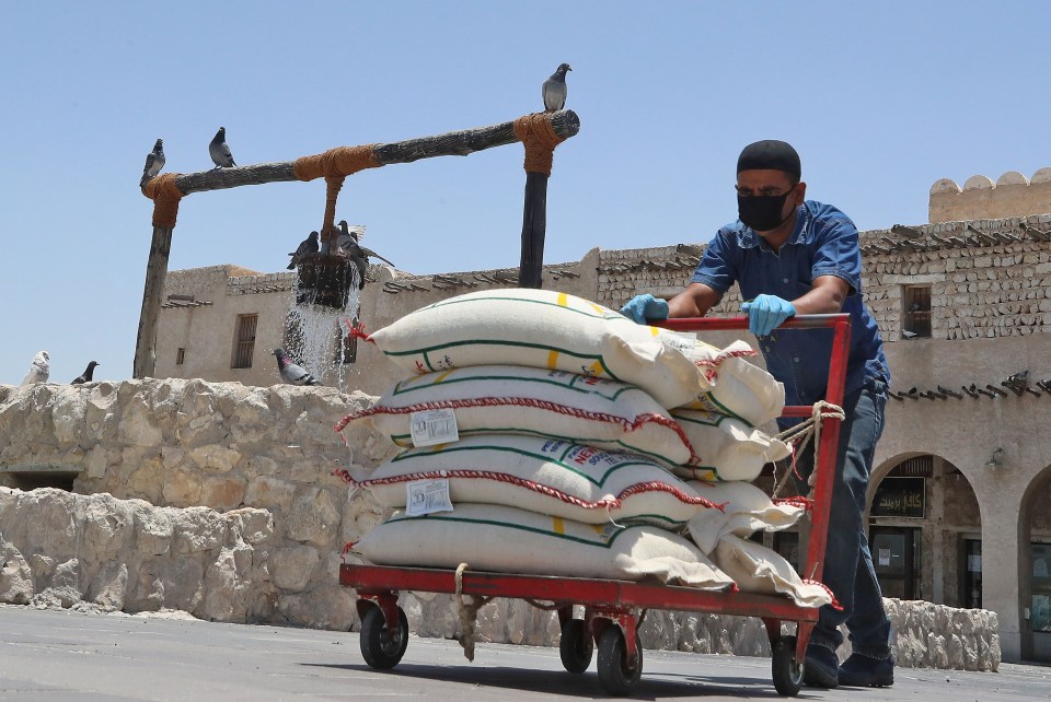 A market porter wears a protective mask at the Souq Waqif bazar in Doha yesterday