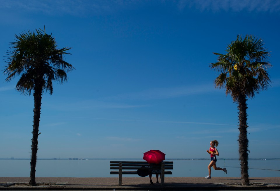  A young woman enjoys a run in the sun on the esplanade at Southend on Sea this morning