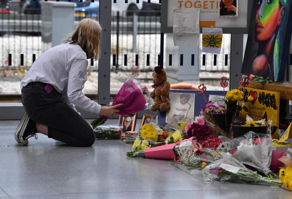 A woman places flowers to remember those killed