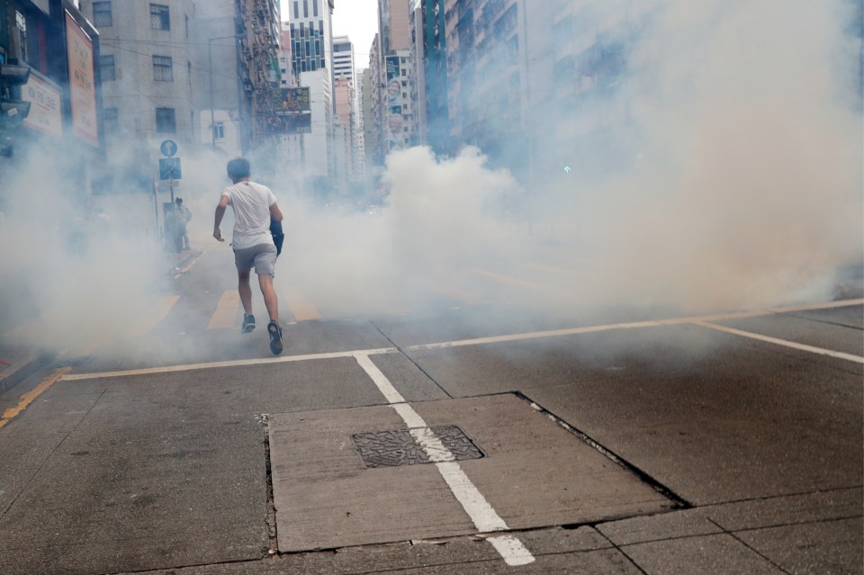  A protesters engulfed by tear gas during a protest against the security law