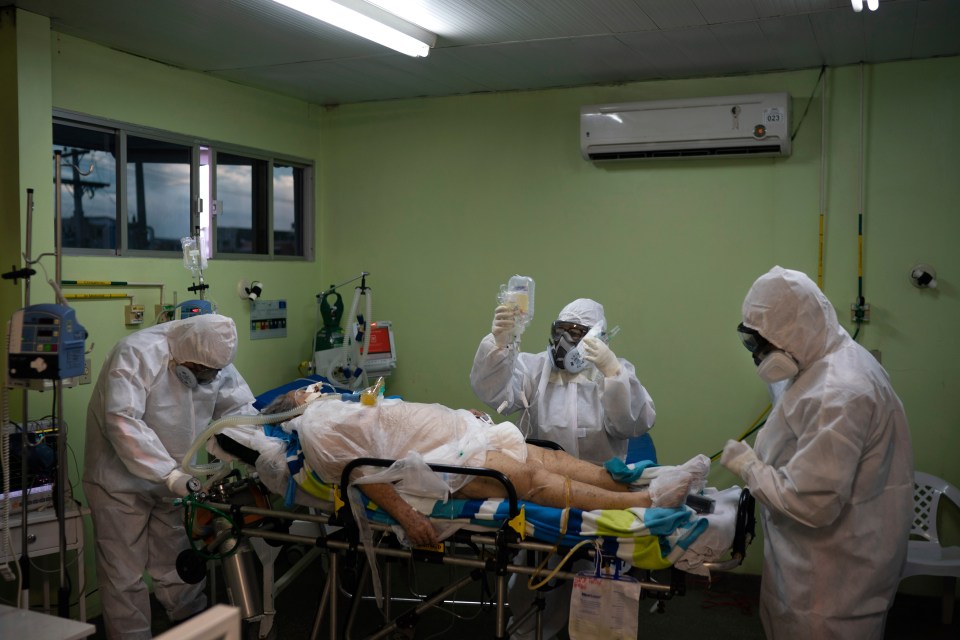  Emergency workers treat a patient in Manaus