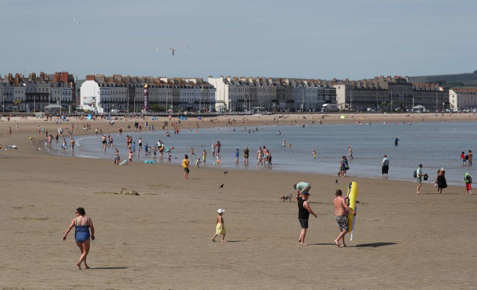  Most people at Weymouth beach, Dorset, paddled in the shallow waters