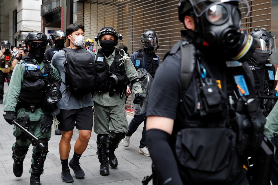  A protester against the new law is led away by police in Hong Kong