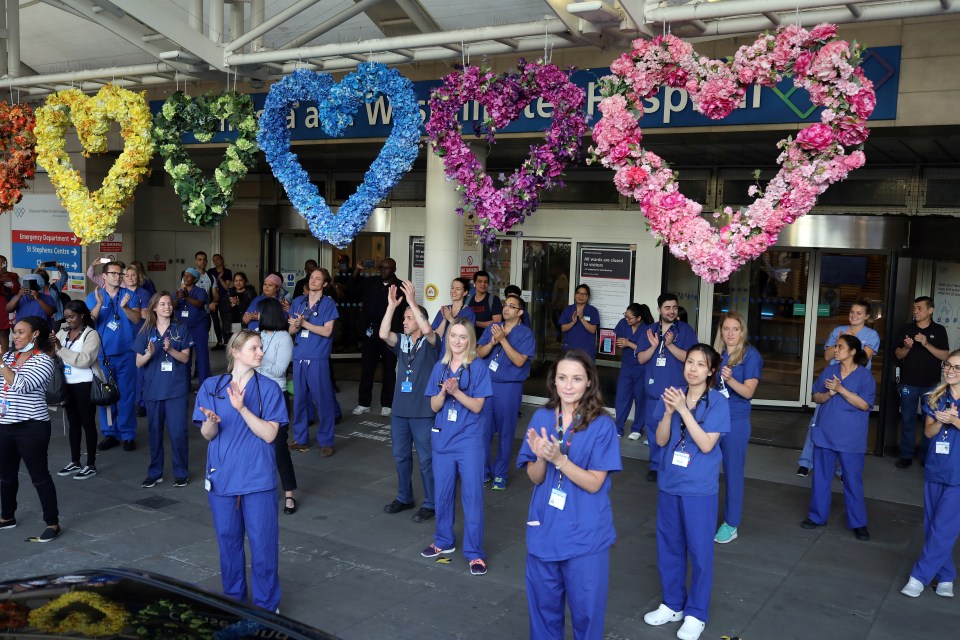 NHS workers and members of the public react at the Chelsea and Westminster Hospital