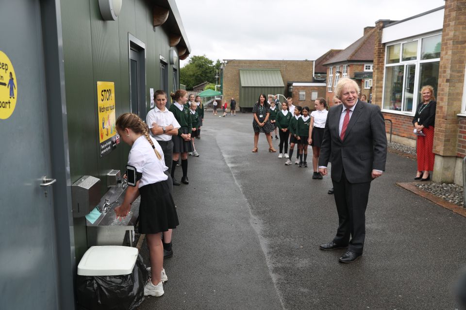  Prime Minister Boris Johnson waits in line in the playground to wash his hands during a visit to Bovingdon Primary School in Bovingdon, Hemel Hempstead, Hertfordshire