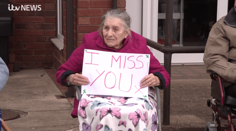  One woman held a sign to show her family they had been missed during the lockdown