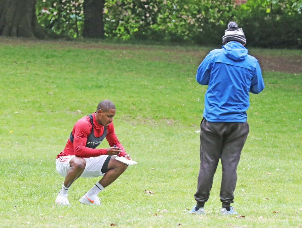  Ighalo signed an autograph for a fan while sticking to social distancing rules