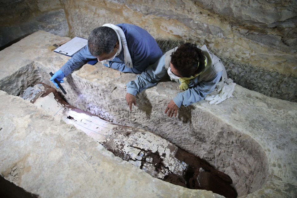 Experts inspect the coffin of a ‘prestigious woman’