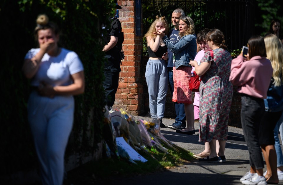 Emotional mourners lay flowers for those killed over the weekend