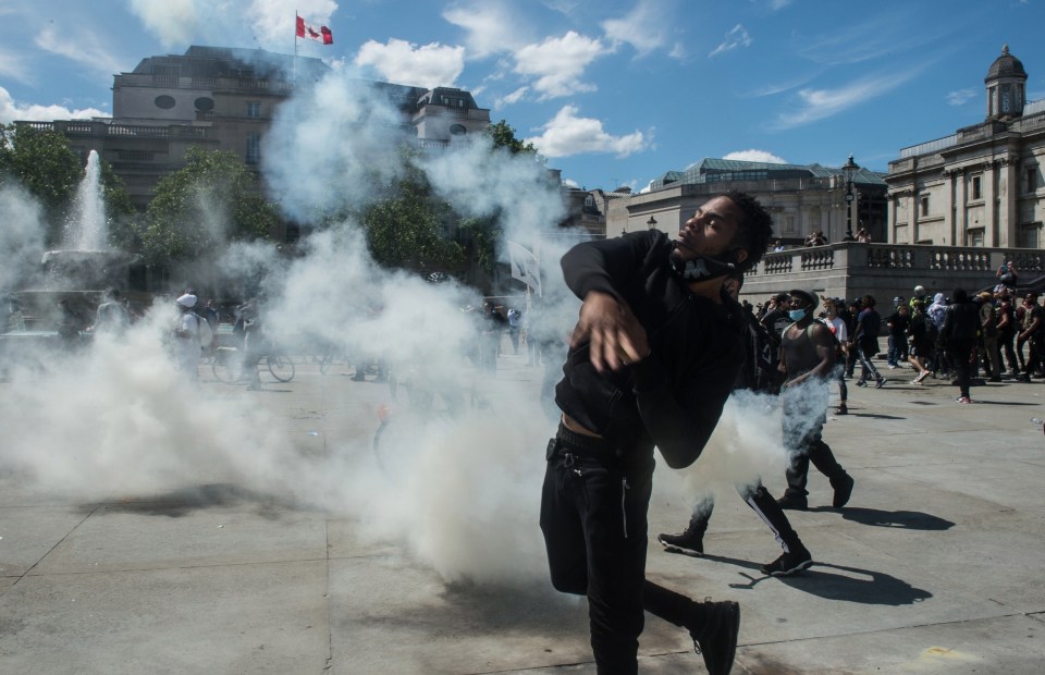 BLM protesters throw back smoke canisters after the counter demo threw them