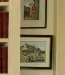 Hanging on the wall is a painting of a man in military dress, and a photo of Charles and Camilla outside their Welsh home, Llwynywermod