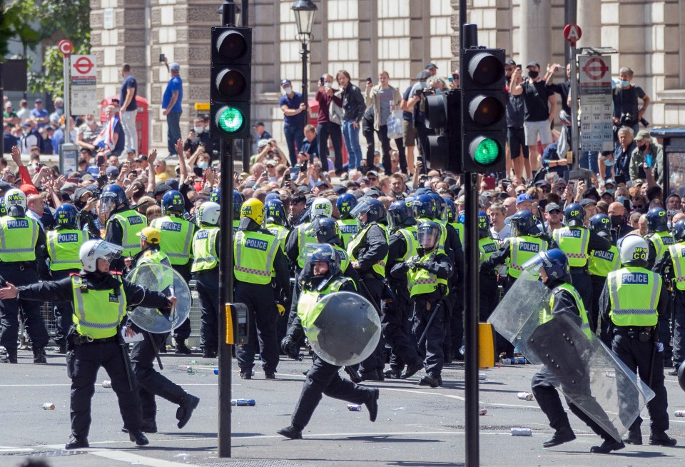 Riot police on the scene in central London yesterday as huge crowds gathered