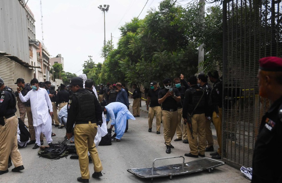 Police work outside the scene of the attack