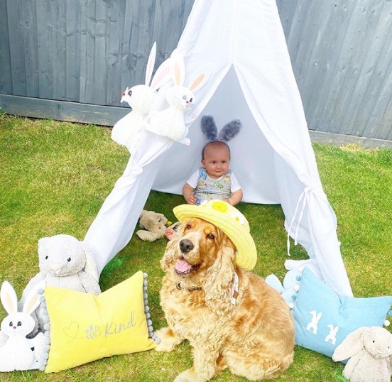 Ronnie has a fun teepee in the garden, pictured with dog Henry