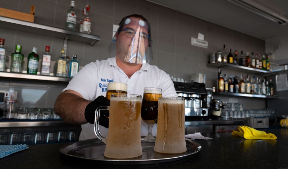 Bars in Spain, such as this one on La Malvarrosa beach in Valencia, have been opening up in recent weeks