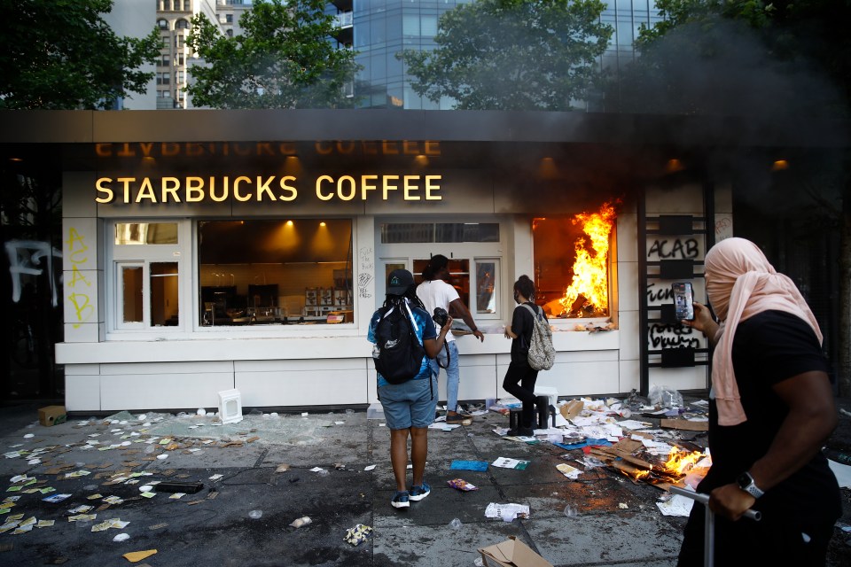 A Starbucks store burns during a protest on Saturday, May 30, 2020, in Philadelphia, over the death of George Floyd