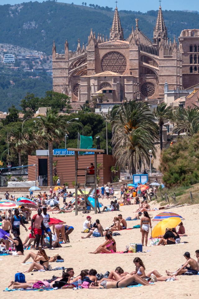 Spaniards enjoy the sunshine at Can Pere Antoni beach during the first Sunday near Palma de Mallorca