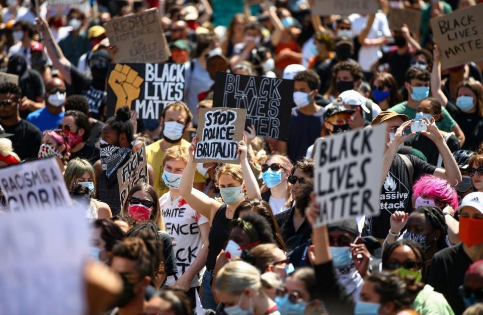  People hold placards as they join a Black Lives Matter march at Trafalgar Square to protest the death of George Floyd in Minneapolis