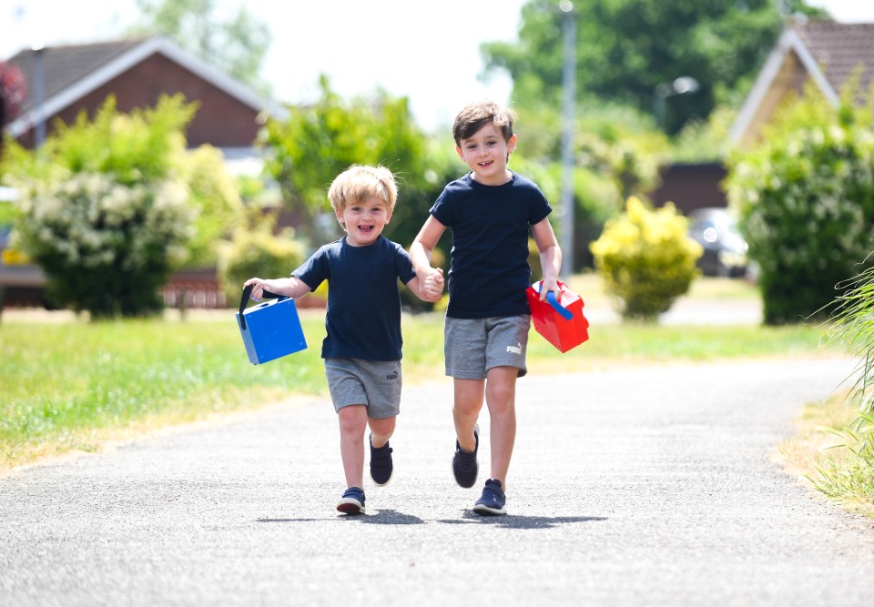  Freddie Noble, six, is seen running to school with three-year-old brother Will - excited at being able to get back to school in West Norfolk