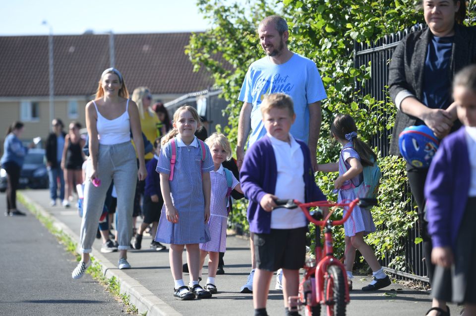  Parents drop off children at Queen's Hill Primary School, Costessey, Norfolk