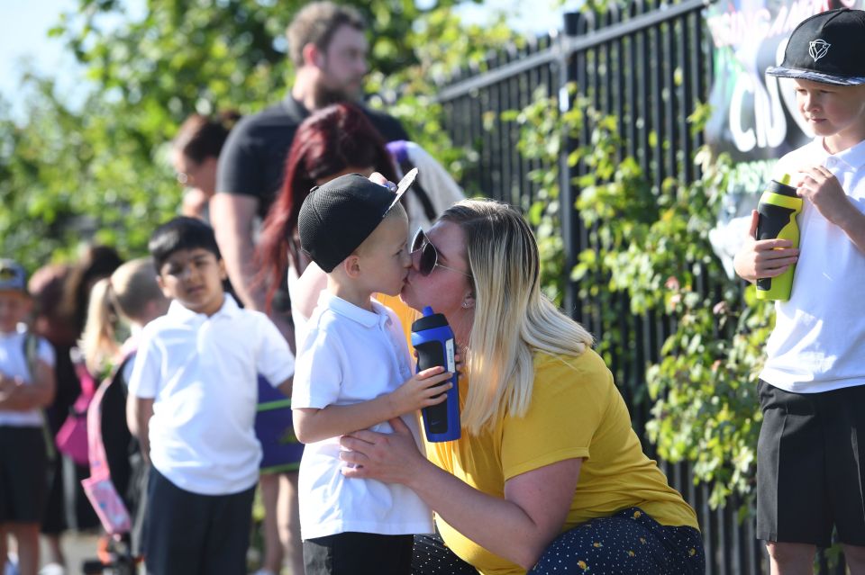  A mum gives her little one a kiss outside Queen's Hill Primary School, Costessey, Norfolk