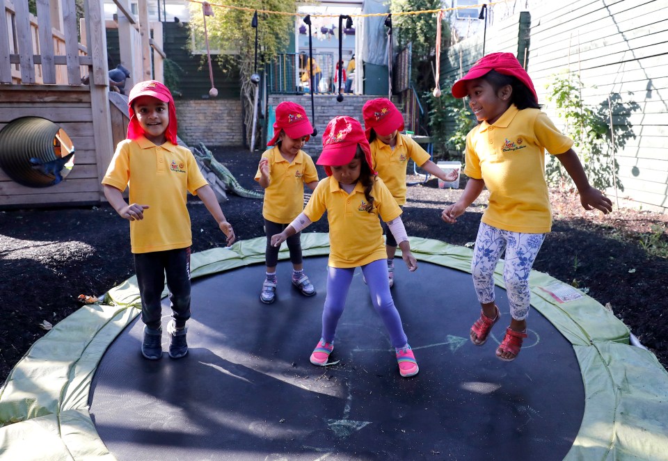  Children jump on a trampoline at the Little Darling home-based Childcare after nurseries and primary schools partly reopen in England