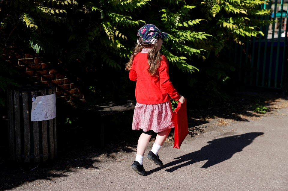  A little girl excitedly skips into Watlington Primary School after the extended break