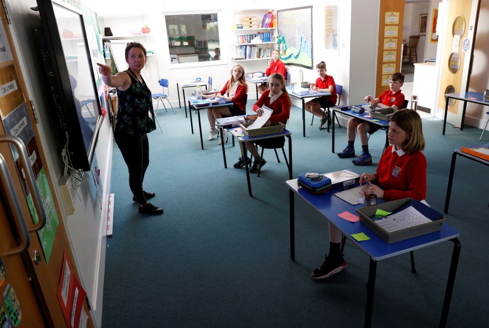  A teacher stands in front of her class at Watlington Primary School that has seen its numbers reduced due to covid