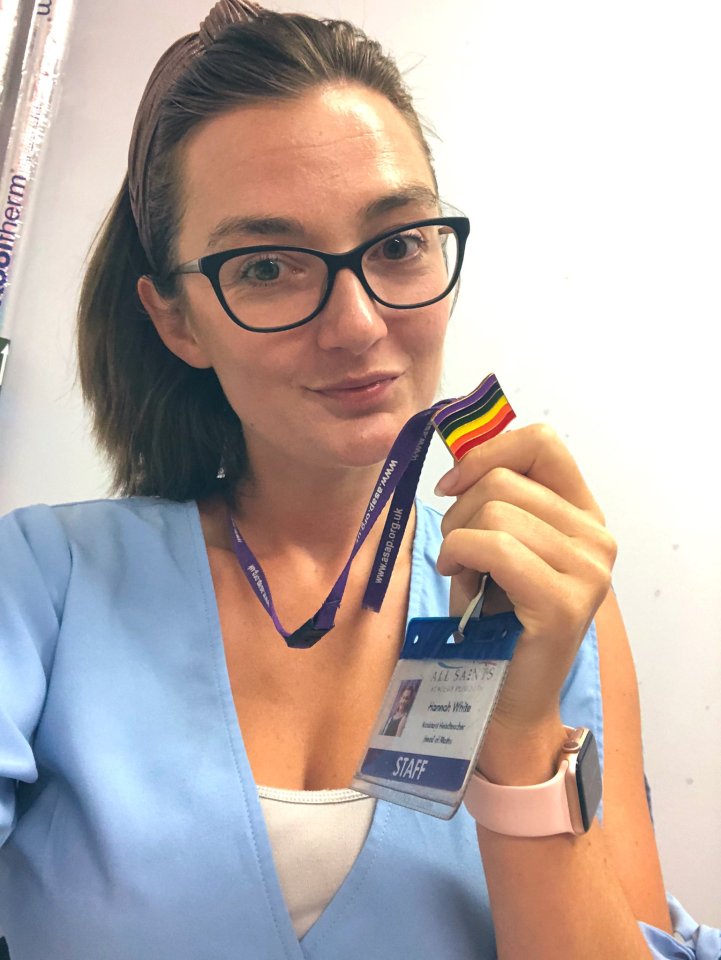  A teacher happily poses with her pride lanyard as she celebrates back to school