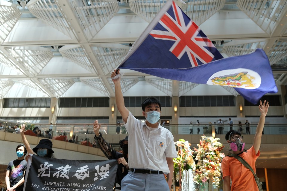  A pro-democracy demonstrator waves the British colonial Hong Kong flag during a protest against Beijing's attempts to take complete control of Hong Kong