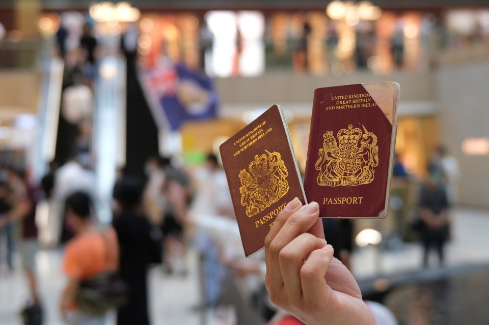  A pro-democracy demonstrator raises his British National Overseas (BNO) passports during a protest against new national security legislation in Hong Kong yesterday