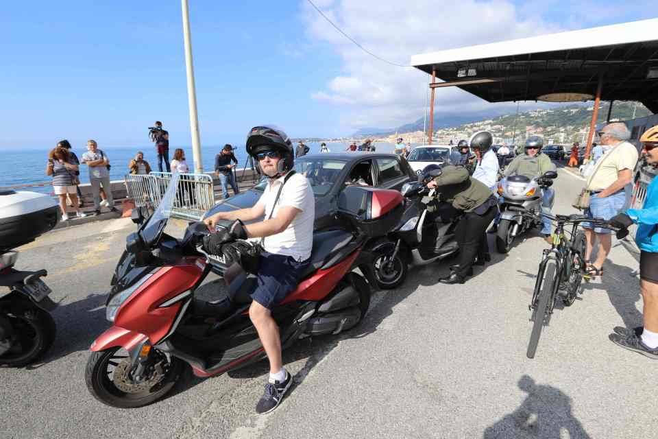  Travellers in car and scooters cross the French-Italian border near Menton on Wednesday