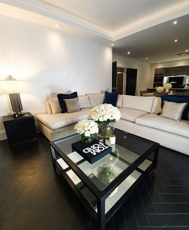 The living room is decorated in darker shades