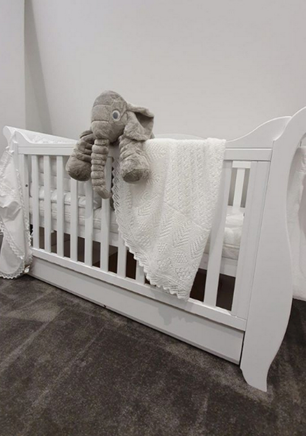 His nursery has been decorated in grey and white