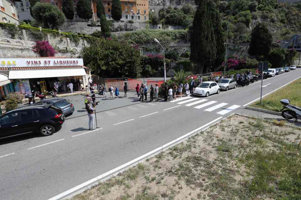  People queue to buy alcohol and cigarettes on the Italian side at the French-Italian border near Menton on Wednesday as Italy reopened its frontiers with Europe