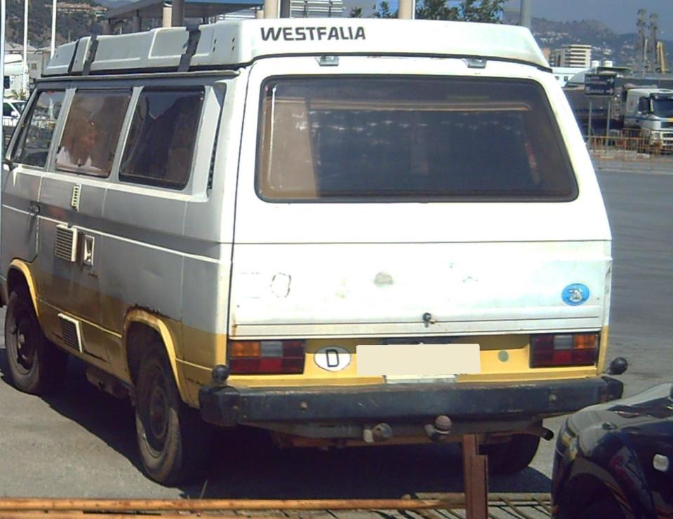 The early 1980s camper van has a white upper body and yellow skirting, registered in Portugal 