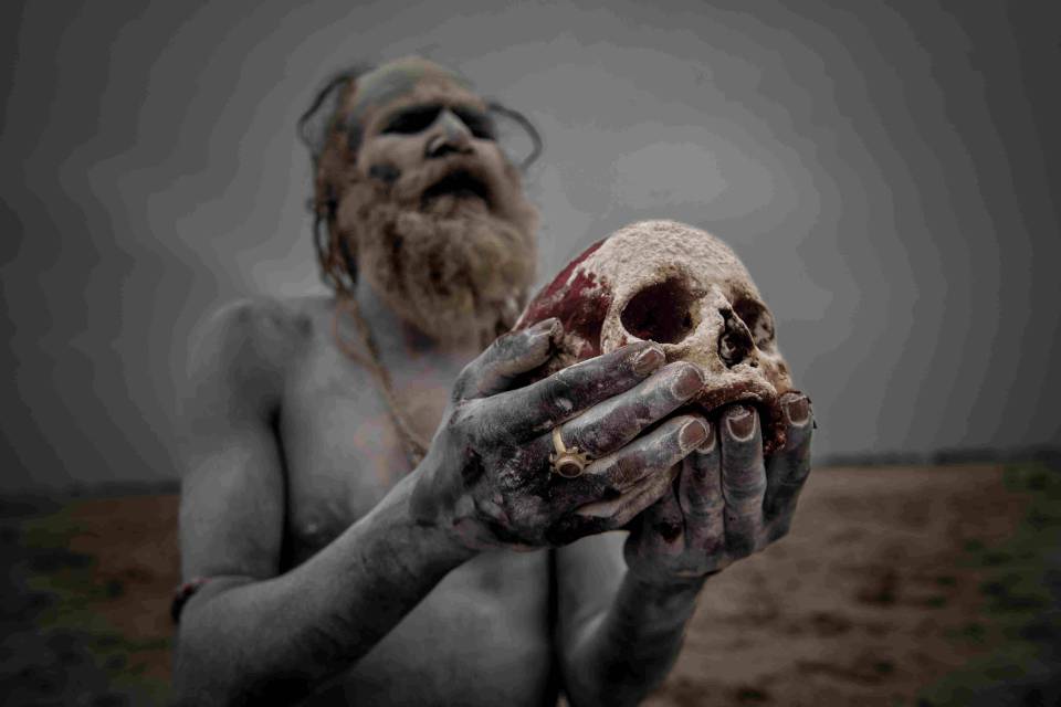  An Aghori member pictured cradling a human skull in his hand