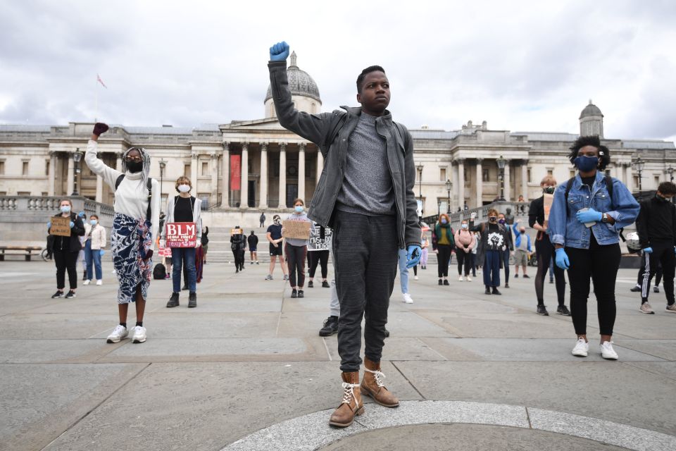 People take part in a kneeling protest for Black Lives Matter in Trafalgar Square, London