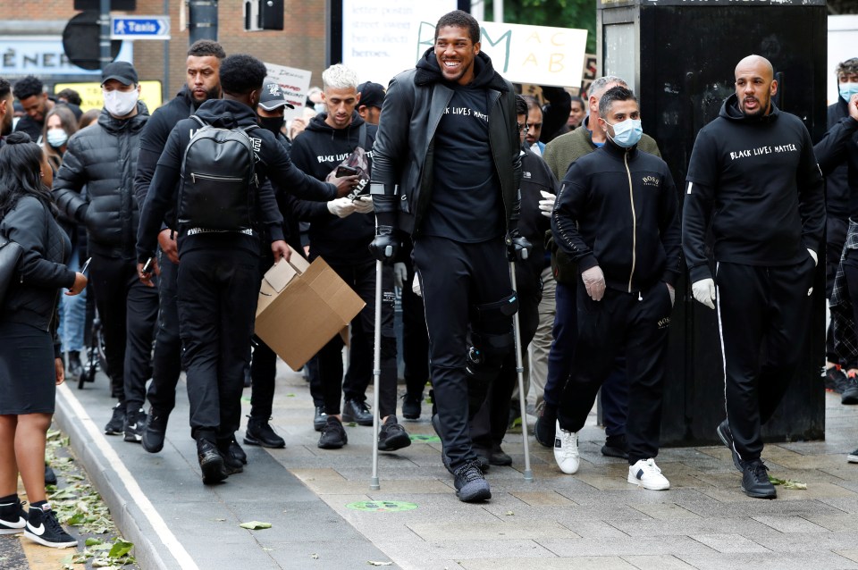 The heavyweight champ attended the peaceful protest in his hometown of Watford