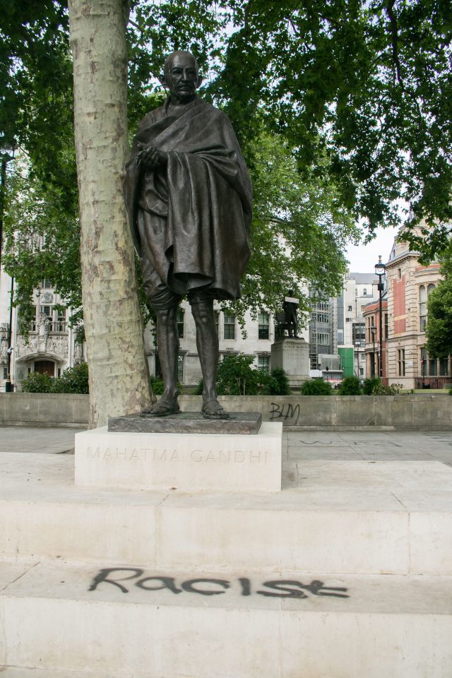 The word racist was scribbled on the base of Mahatma Gandhi's statue