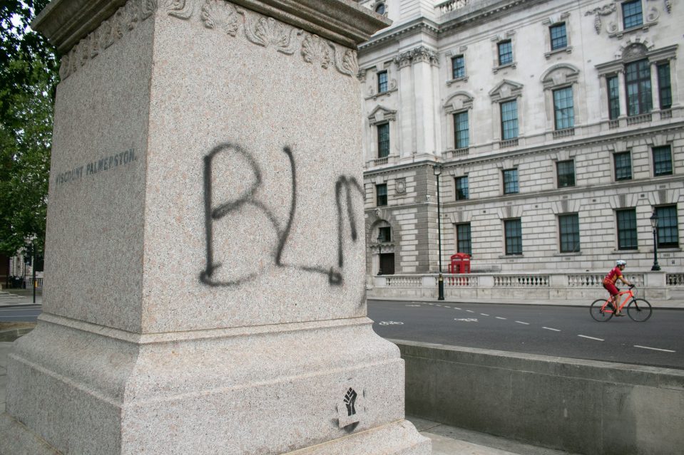 A statue in Parliament Square is covered in graffiti