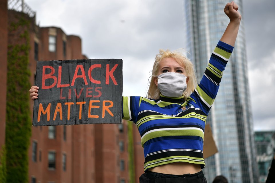  A woman holds up a sign outside the US Embassy on Sunday