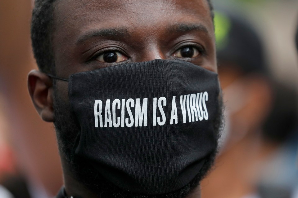 A protester wears a face mask outside the US embassy