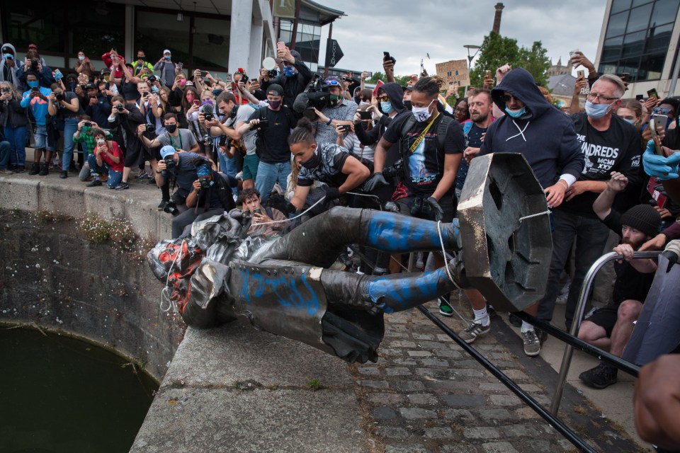 The statue of slavetrader Edward Colston is thrown into the River Avon by Black Lives Matter protesters