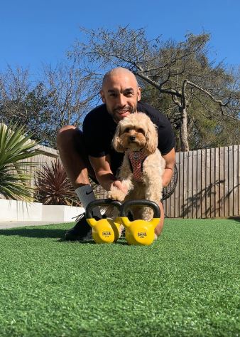 Alex working out with the help of his pooch Peaches