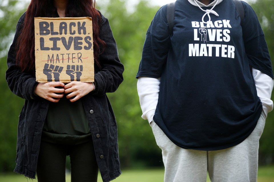 Protesters don Black Lives Matter t-shirts and placards